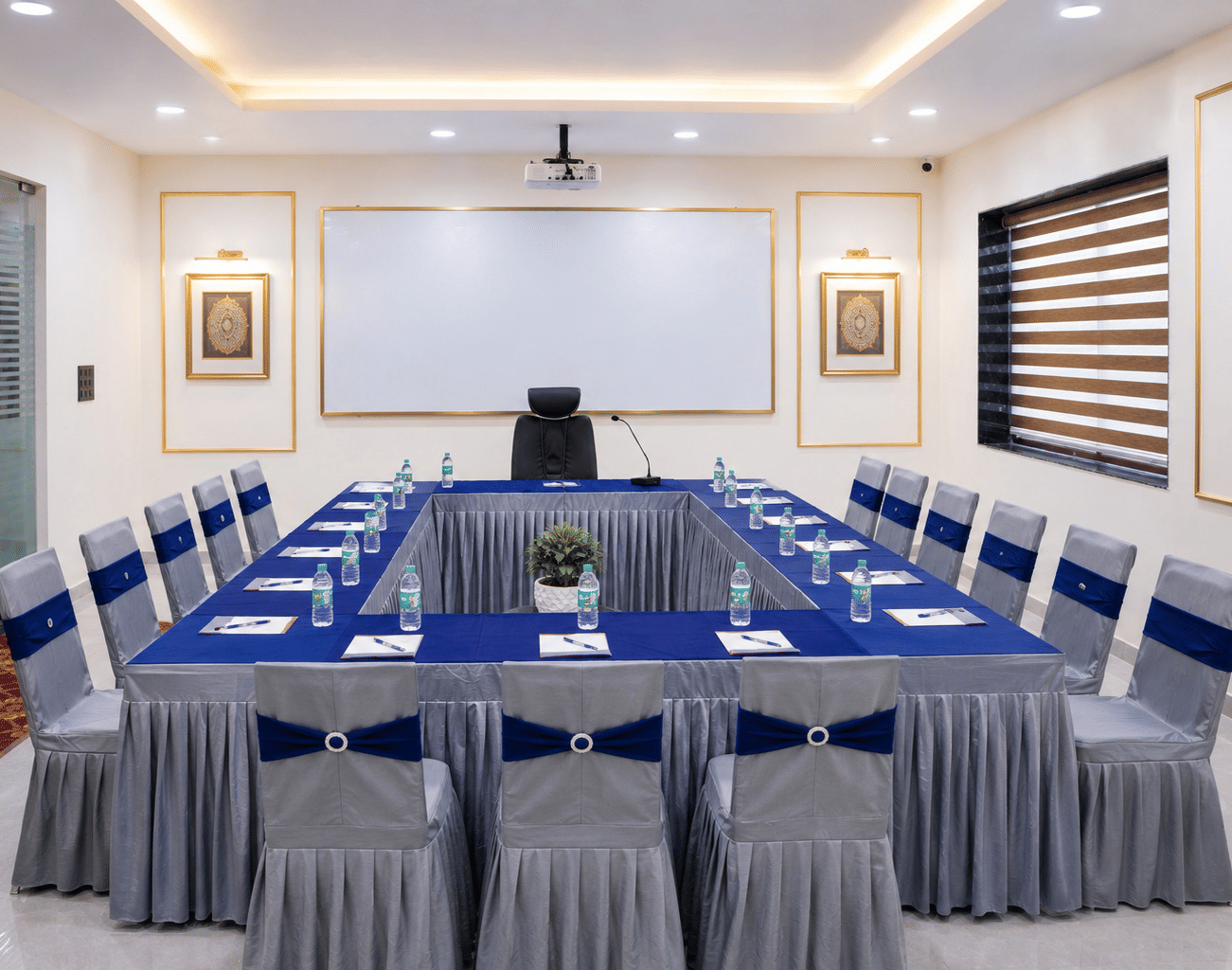 The formal meeting space of Galadari Boardroom at Hotel Galadari arranged with a large table, multiple chairs, and a whiteboard.