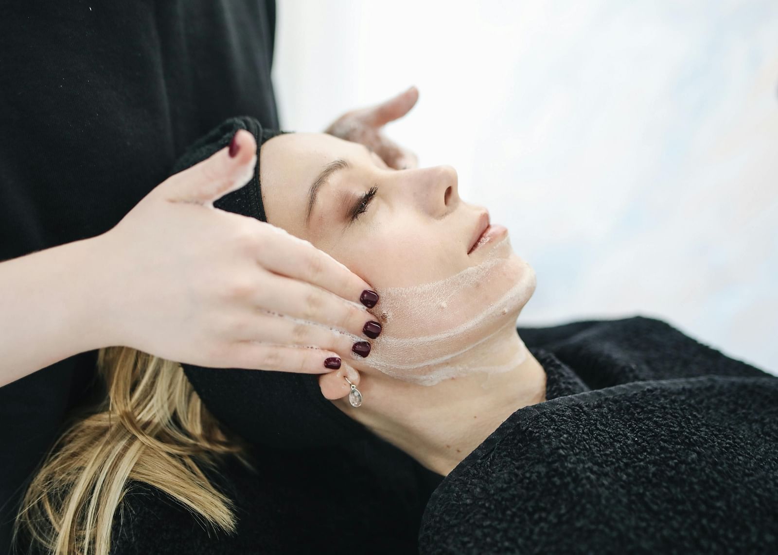 A woman getting a facial massage done.