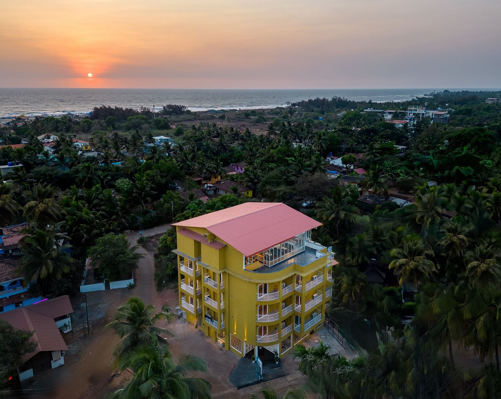 An aerial view image of a facade surrounded by trees - Bedzzz Xclusiv Morjim, Goa
