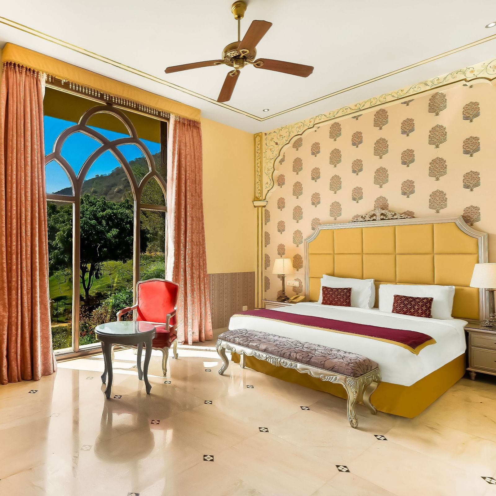 An overview of a room with a double bed, side tables and ceiling fan in view - Rajasthali Resort & Spa, Jaipur.