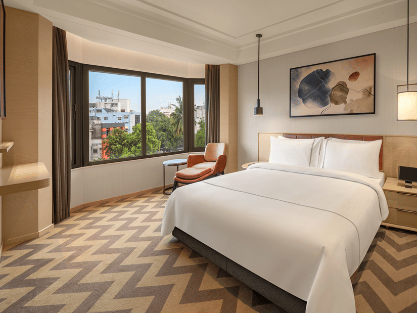 Suite room featuring a cosy bed and elegant bedside lamps at The Residency Chennai