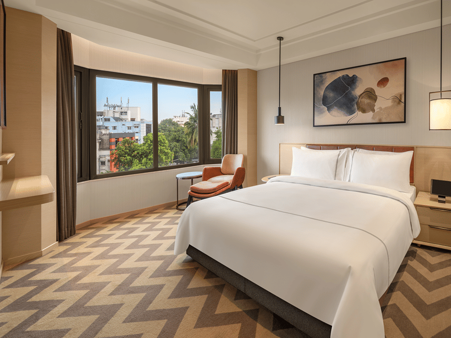 Suite room featuring a cosy bed and elegant bedside lamps at The Residency Chennai