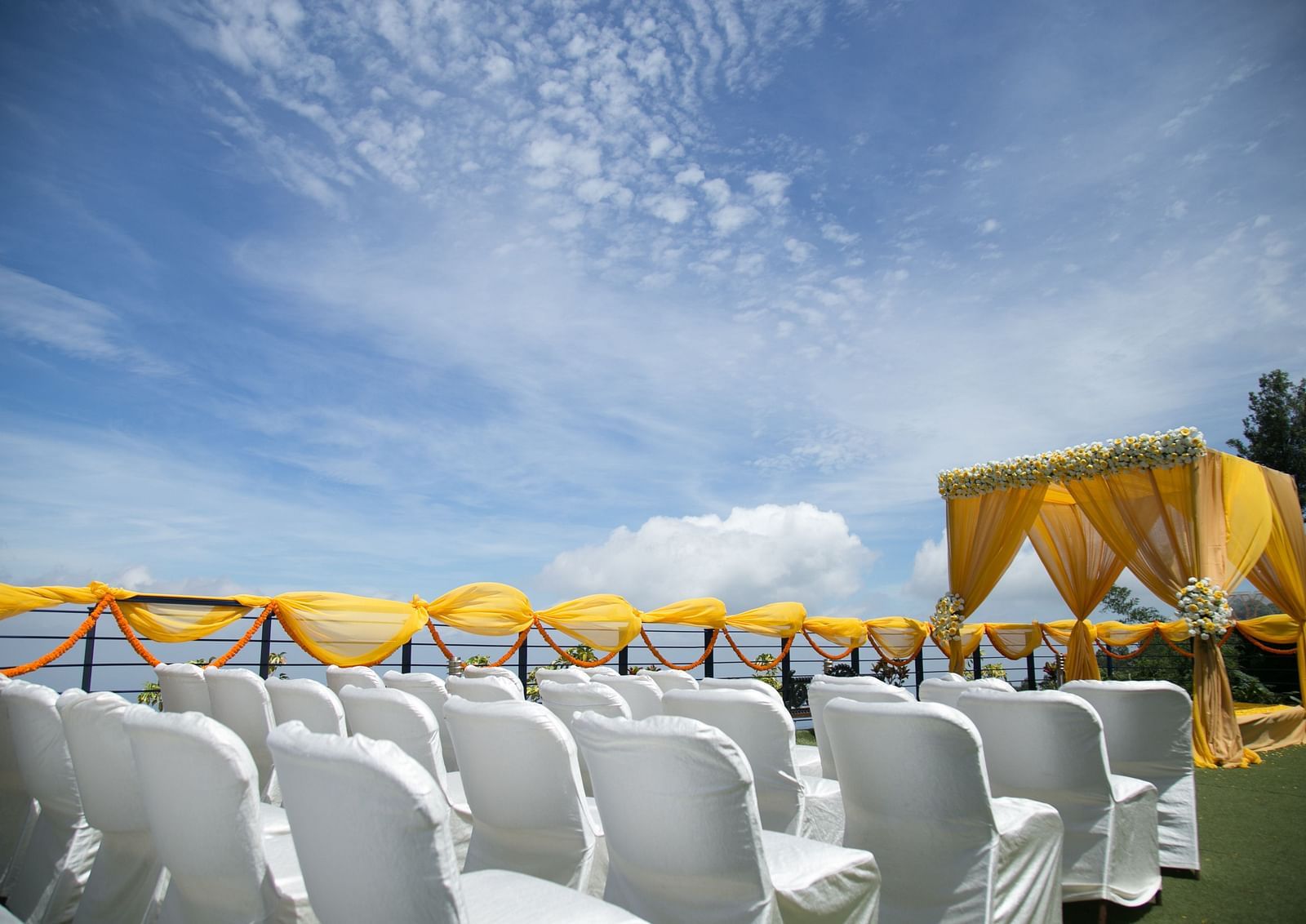 An image of the open banquet space with chairs and decoration - Great Trails Yercaud by GRT Hotels