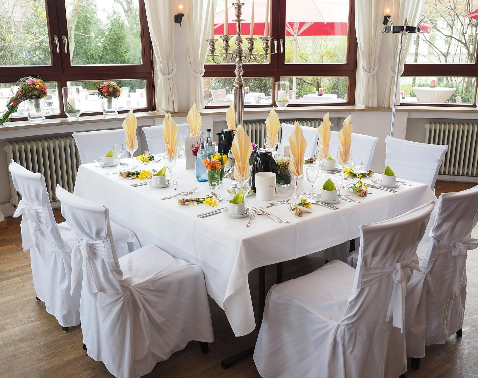 A table and chairs, elegantly decorated and arranged for an event.