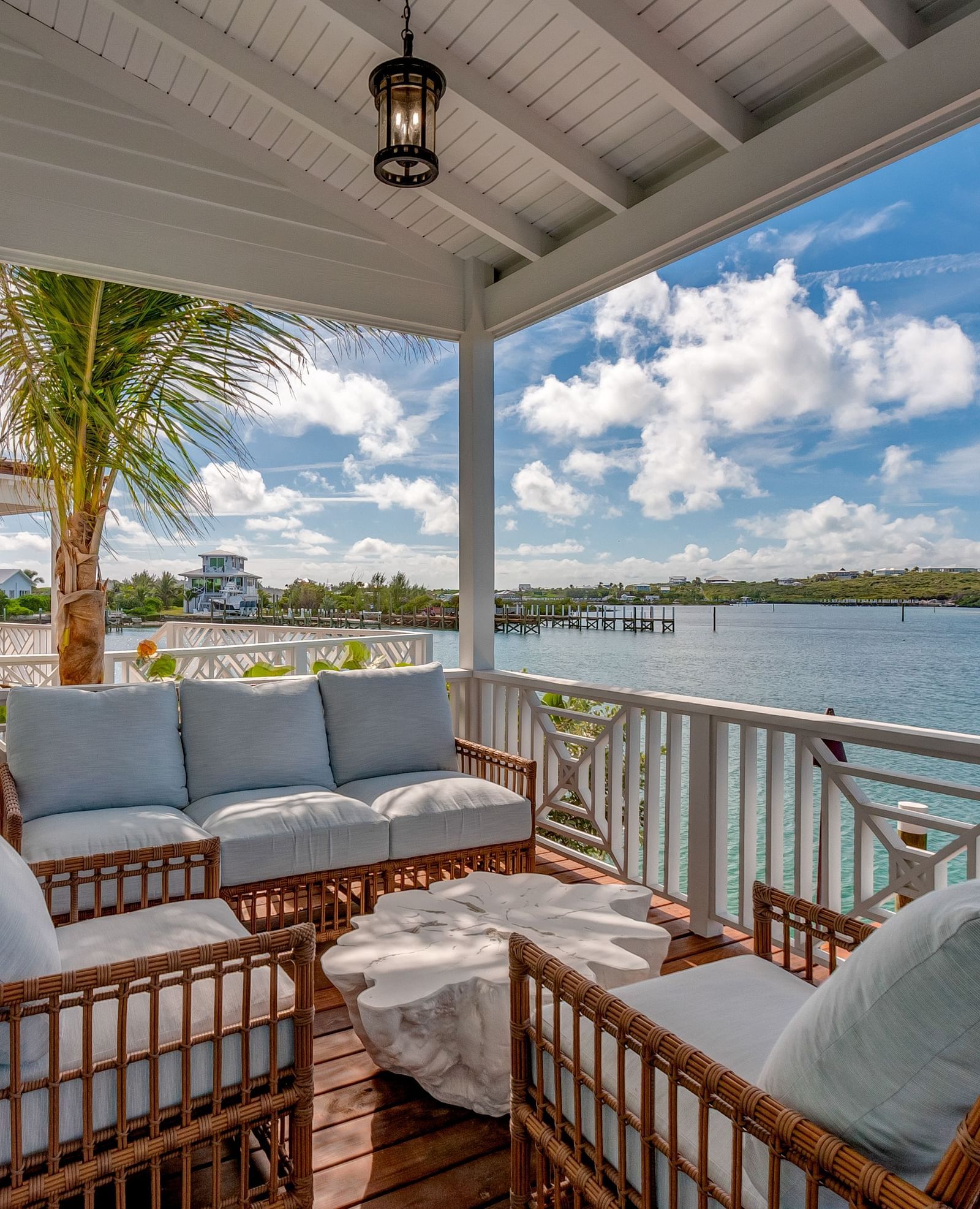 Covered balcony with plush seating and sea views | Abaco Inn