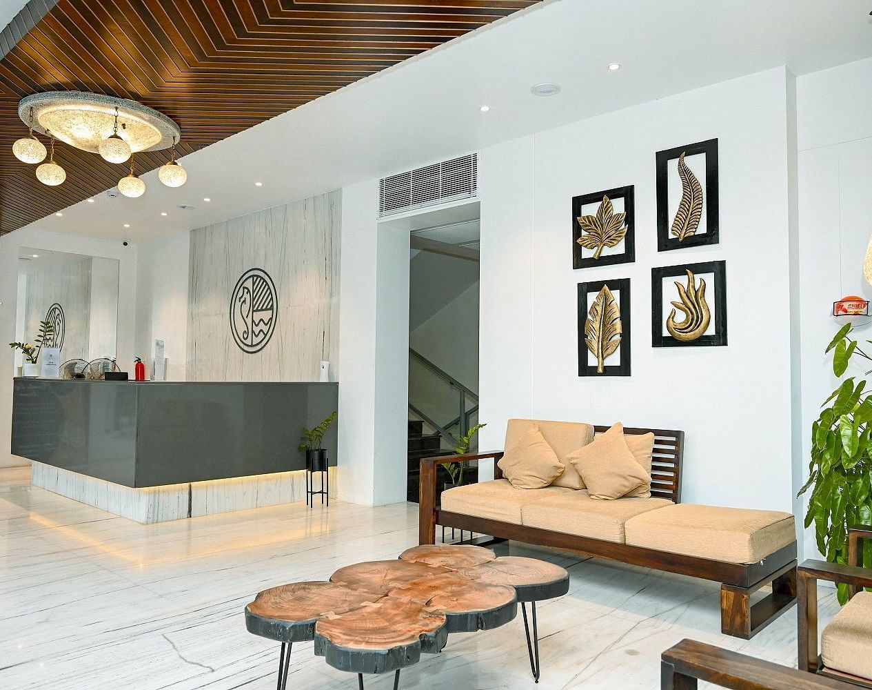 A chic hotel reception with modern furniture, decorative lighting, and wall art - Sea Hills Hotels, Sri Vijayapuram (Port Blair)