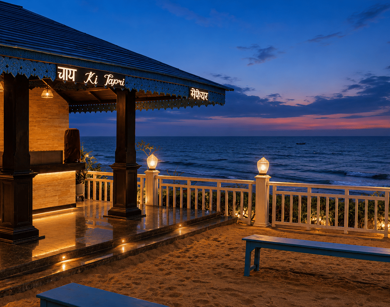 Beachfront Chai Ki Tapri tea kiosk with a blue pitched roof, illuminated signage and bench seating on the sand at MAYFAIR Palm Beach Resort, Gopalpur-on-Sea.