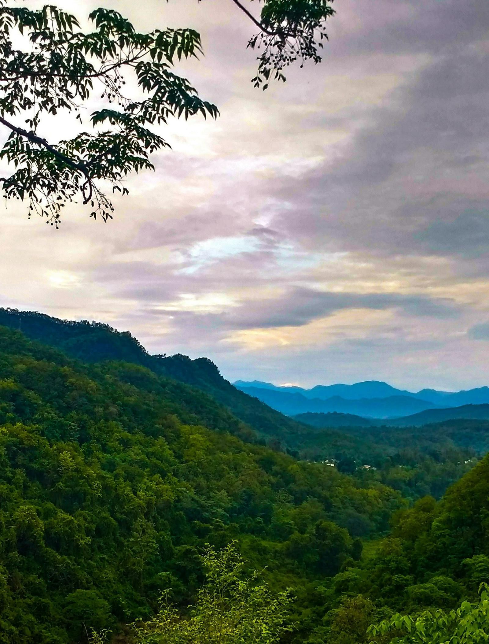 a mesmerising landscape of dehradun with a beautiful sky with clouds in the background