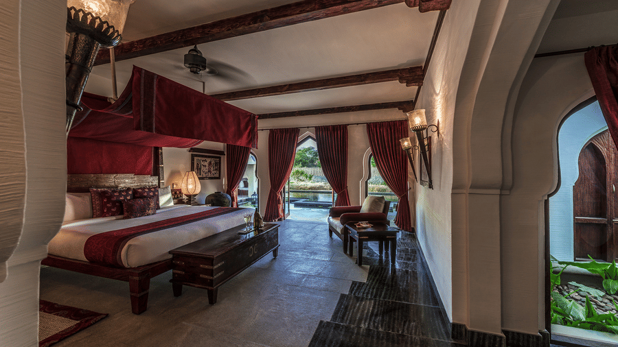 Luxury heritage bedroom with arched ceiling and royal décor at Evolve Back Hampi