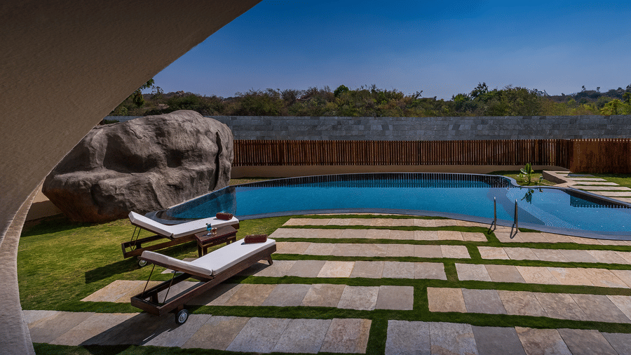 Private pool villa with natural rock boulders at Evolve Back Hampi