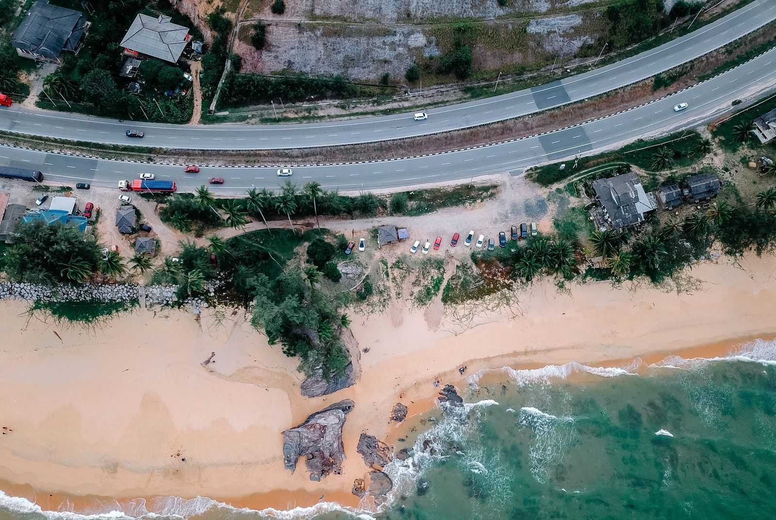 Top view of road where it is closest to a beach