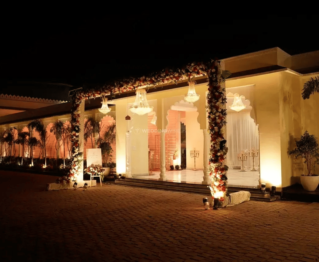 Building exterior illuminated with lights during evening at Beelwa Palace, Jaipur