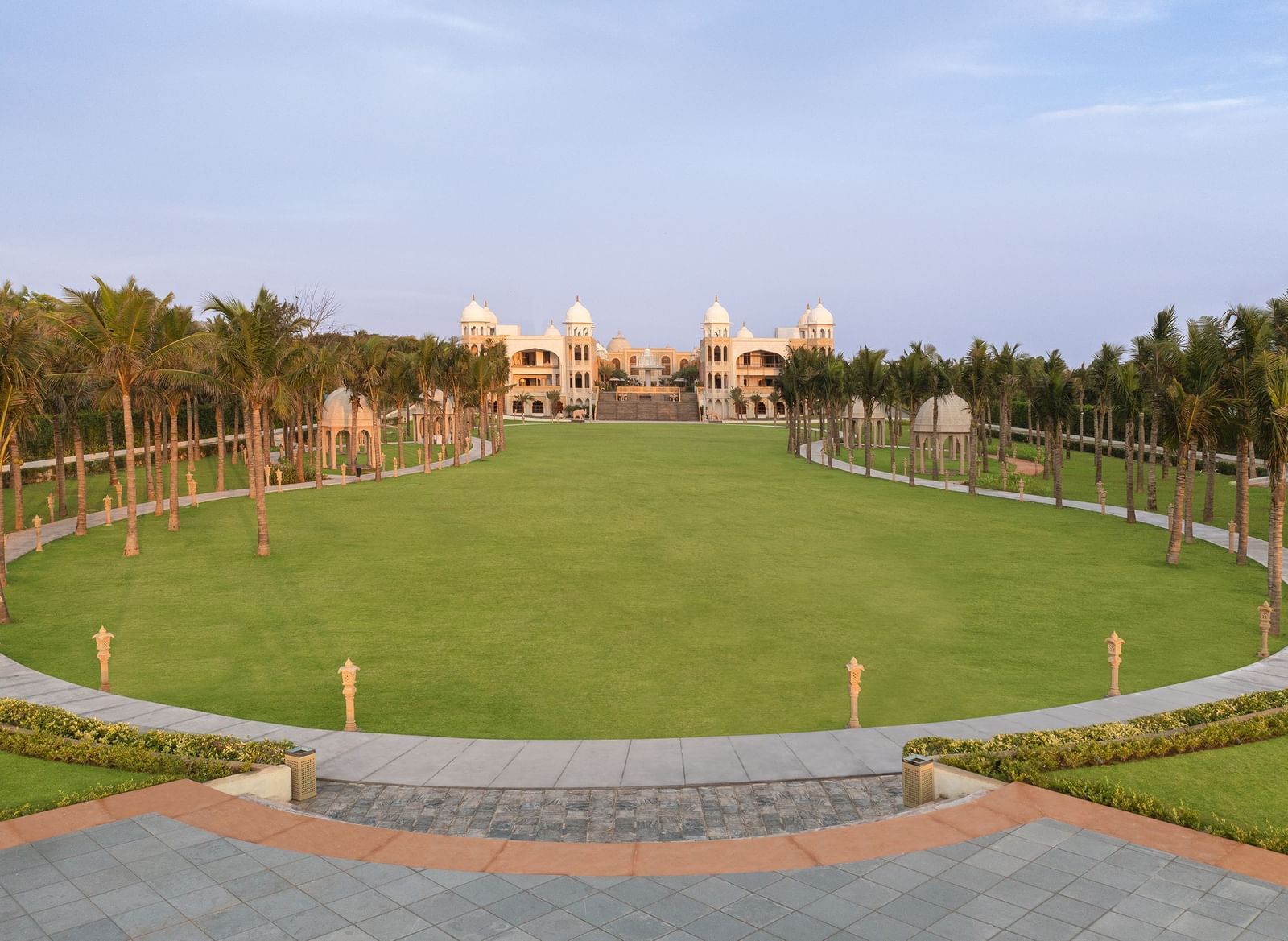 An oval-shaped outdoor lawn in Mahabalipuram surrounded by lights and lush greenery – Kaldan Samudra Palace, Mahabalipuram, one of the Best Marriage Lawns in ECR