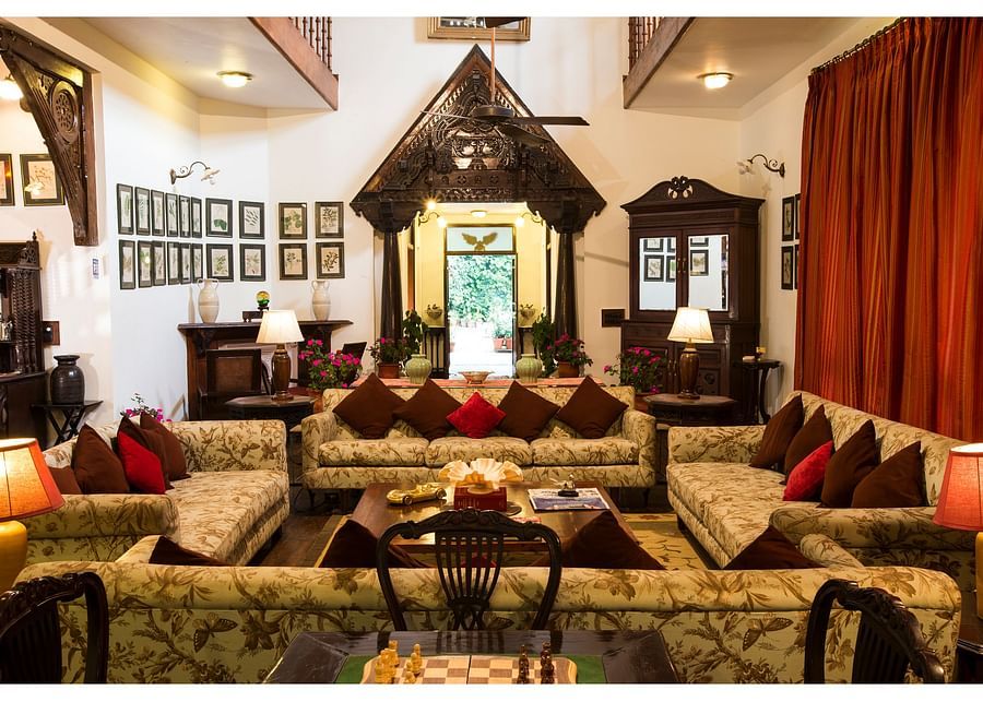 A spacious living room with traditional decor and high ceilings.