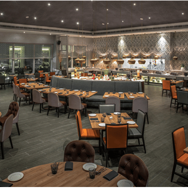 Restaurant at The Residency Towers Rameswaram featuring dining tables and chairs