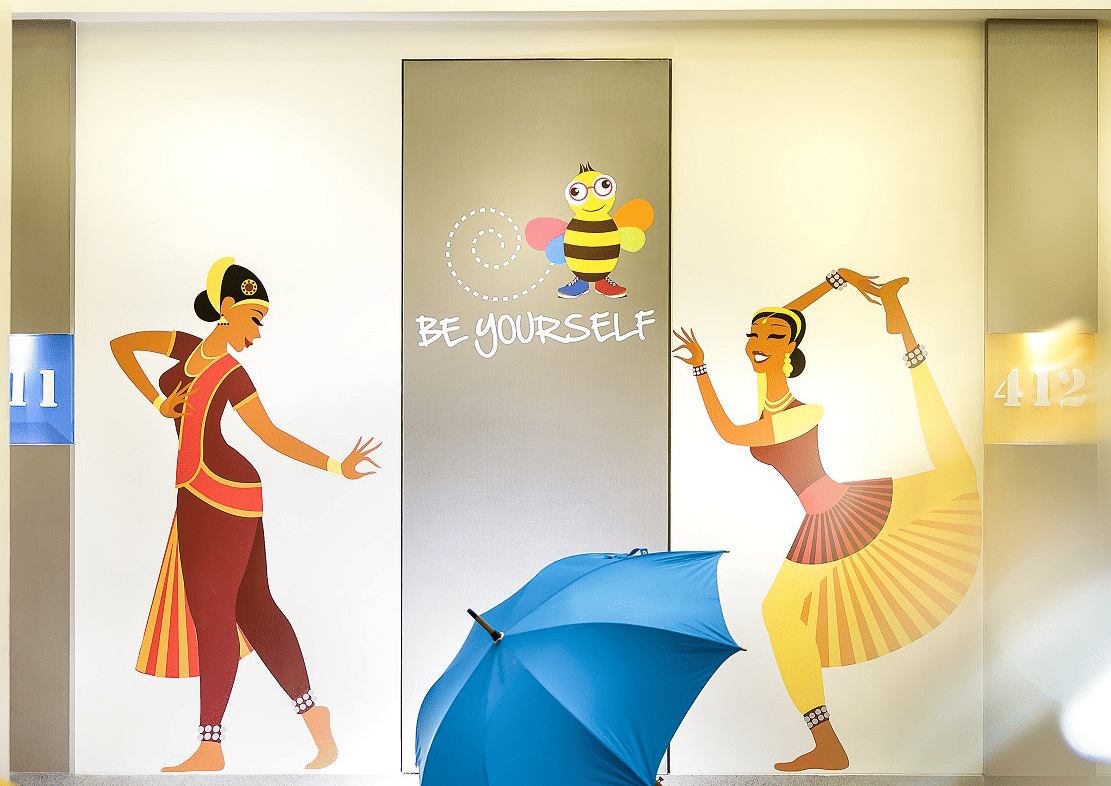  Two women performing Bharatanatyam are painted on the wall