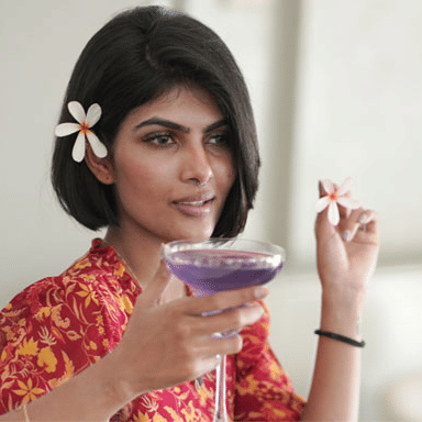 a girl holding a cocktail glass at The Residency Towers Rameswaram