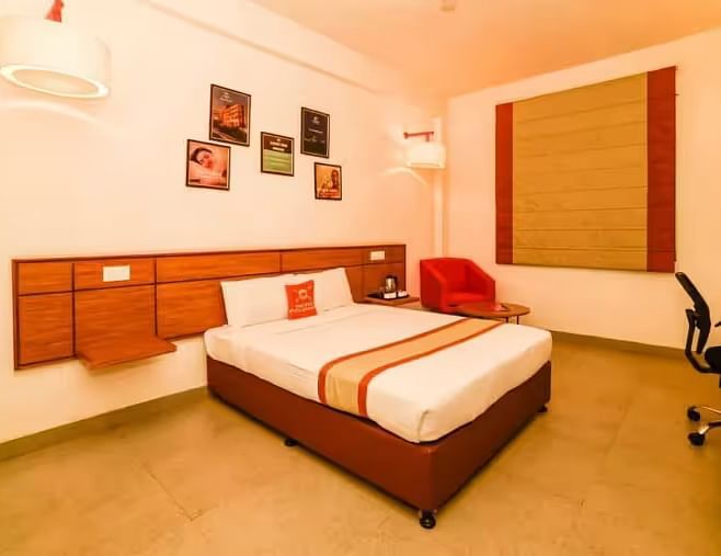 A stylish and cosy hotel room with a king size bed, soft lighting, and contemporary decor - Max Hotel Prayagraj.