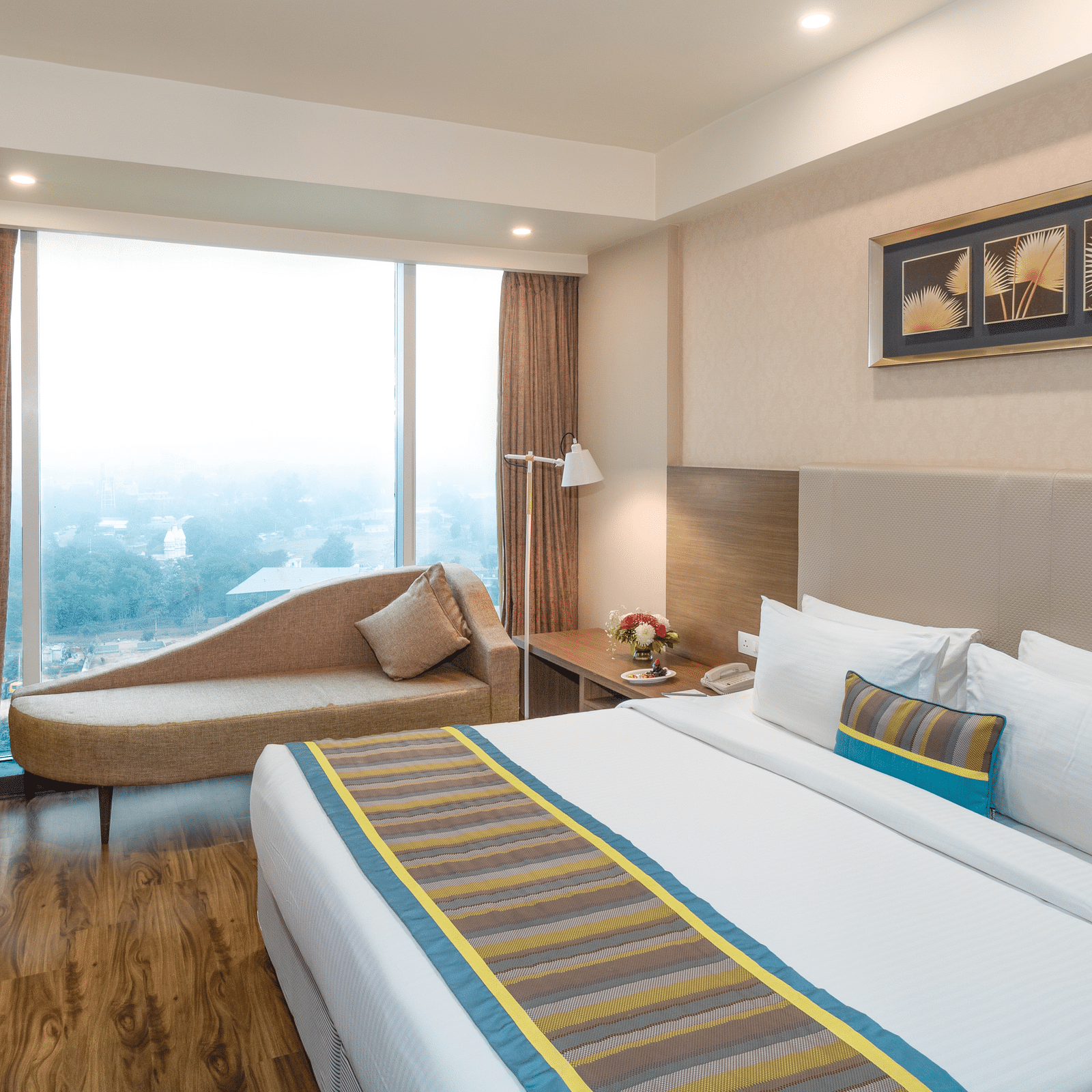 Suite Bed room with comfy bed and window view at golden suite