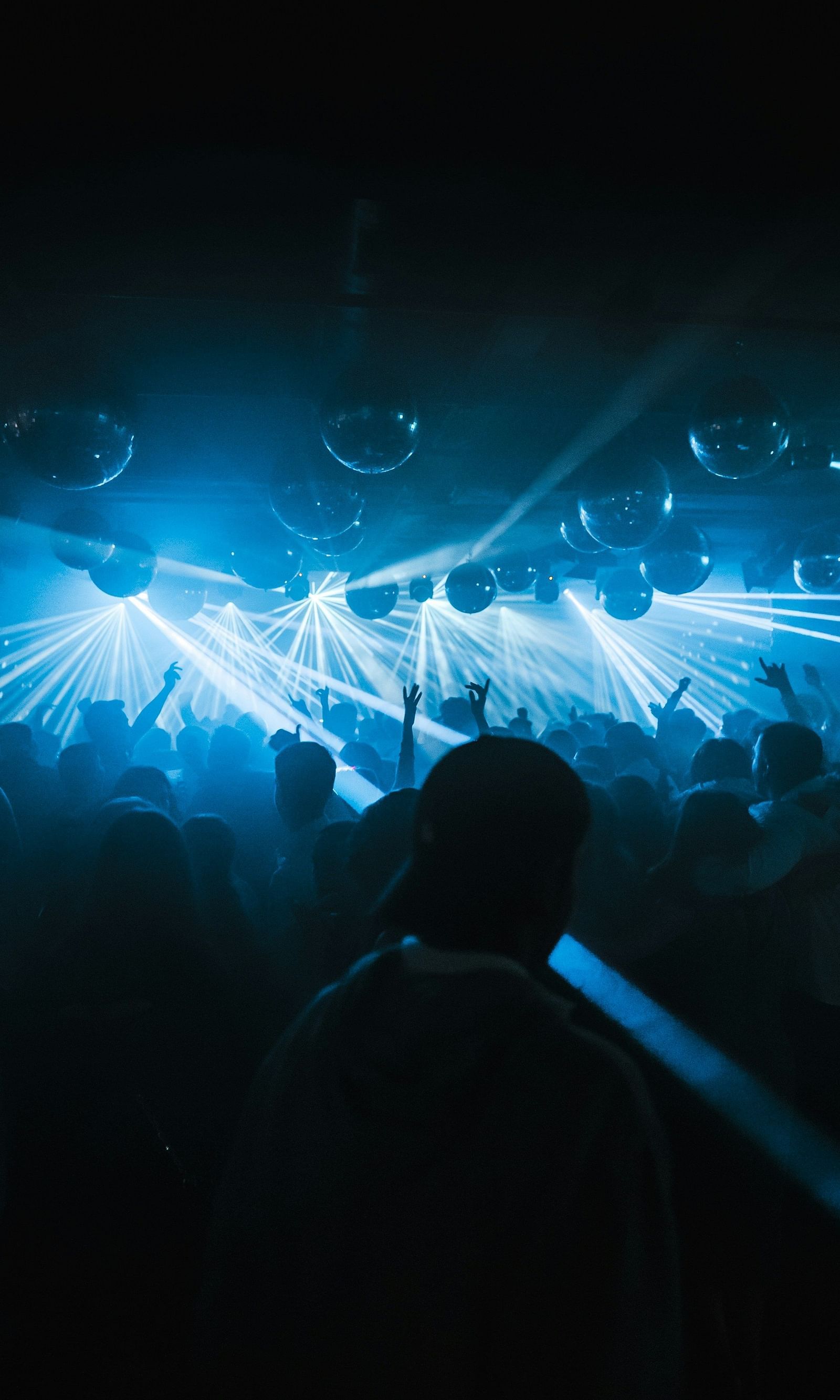  Disco lights flash in vibrant patterns over the dance floor, where people revel in the pulsating beat, their movements lively and carefree