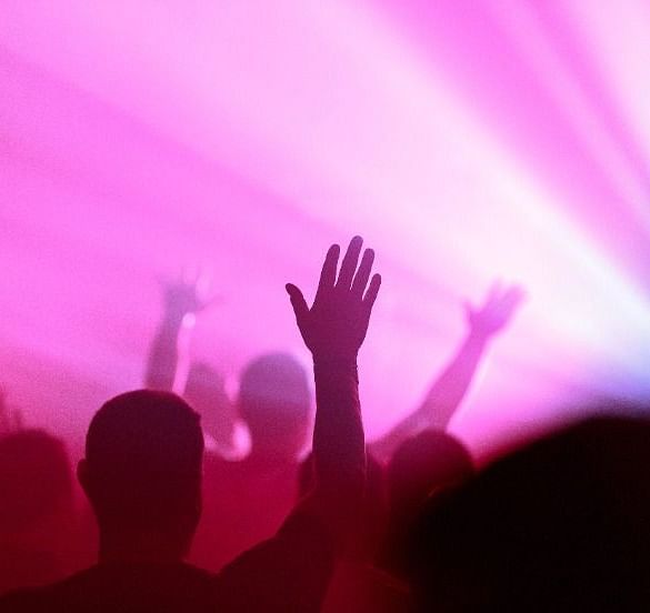  A disco area filled with vibrant lights and silhouettes of people