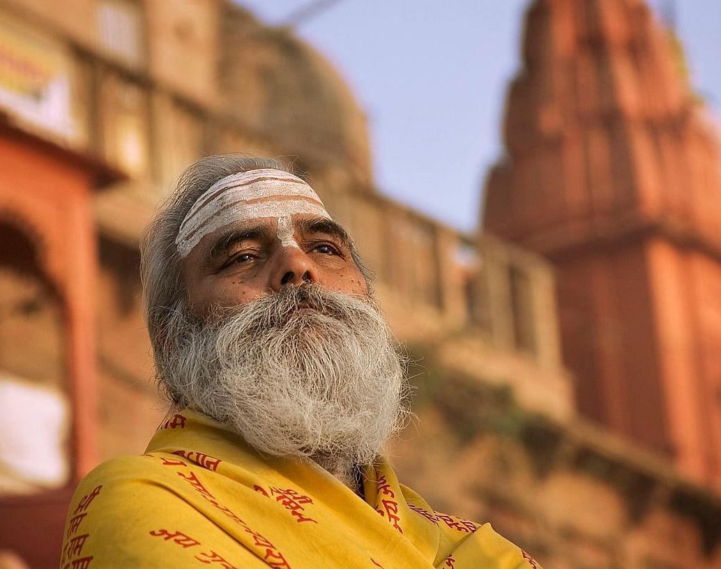 An close-up image of a man with a blurred building in the background