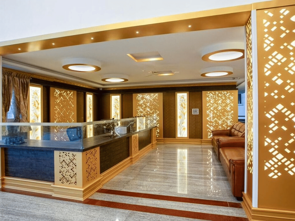 Duplicate of Stylish reception area with golden panelling and modern ceiling lights at Siri Ambari Resorts and Spa.