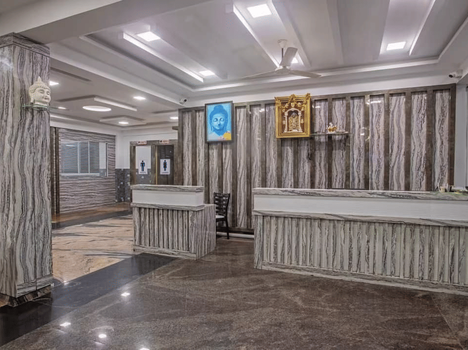 Elegant hotel reception area with wooden decor and modern lighting at Siri Ambari Resorts and Spa.