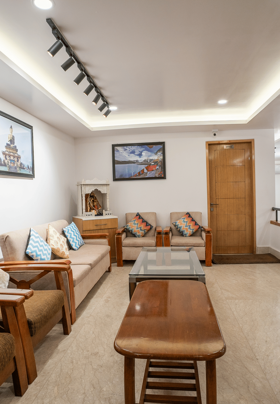 Reception area with brown chairs and brown table at Summit Grand Resort & Spa.
