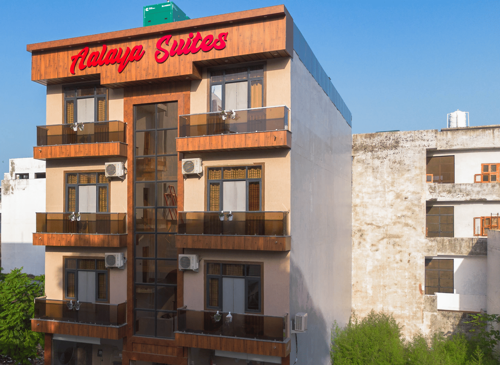 Exterior view of the multi-storey hotel building with 'Aalaya Suites' written on top under a bright blue sky - Perfectstayz Value Aalaya Suites, Haridwar