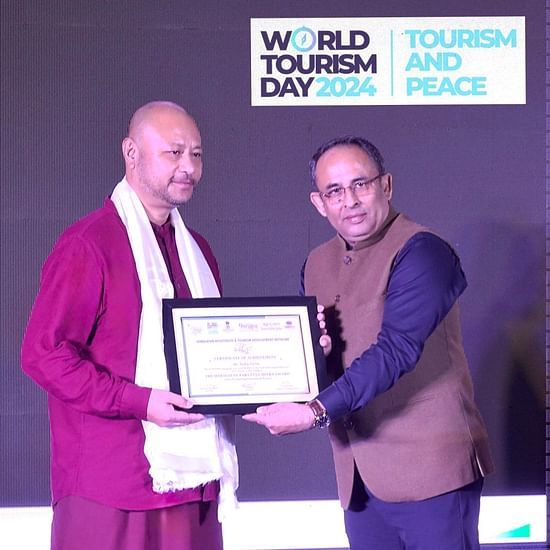 Man receiving an award at World Tourism Day 2024 event