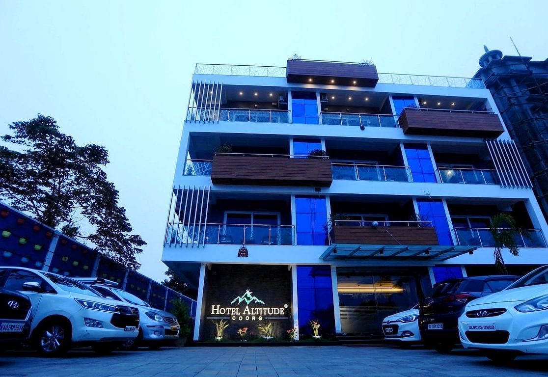 Facade of Hotel Altitude, Madikeri with carks parked in front of it at Hotel Altitude, Madikeri.