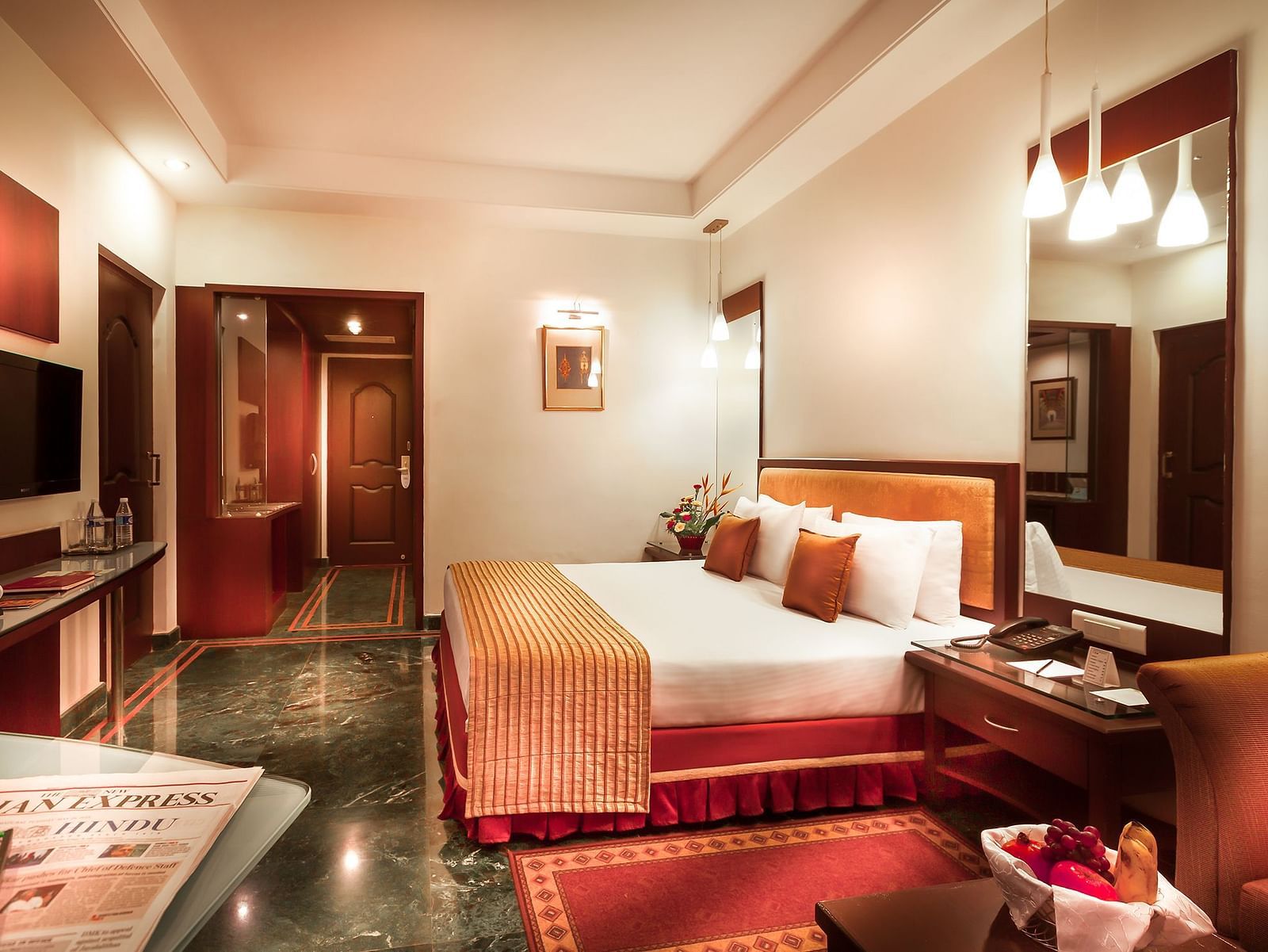 An image of a bedroom with lights hanging from the ceiling at Regency Madurai by GRT Hotels