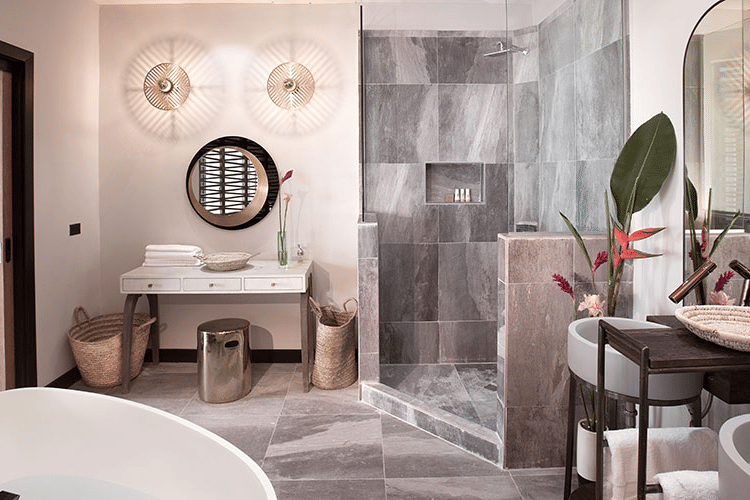 A modern bathroom with a double vanity featuring round mirrors and sleek fixtures.