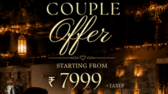 A creative with a couple facing each other in a candle light dinner setup with validity and pricing. | Pride Plaza Ahmedabad