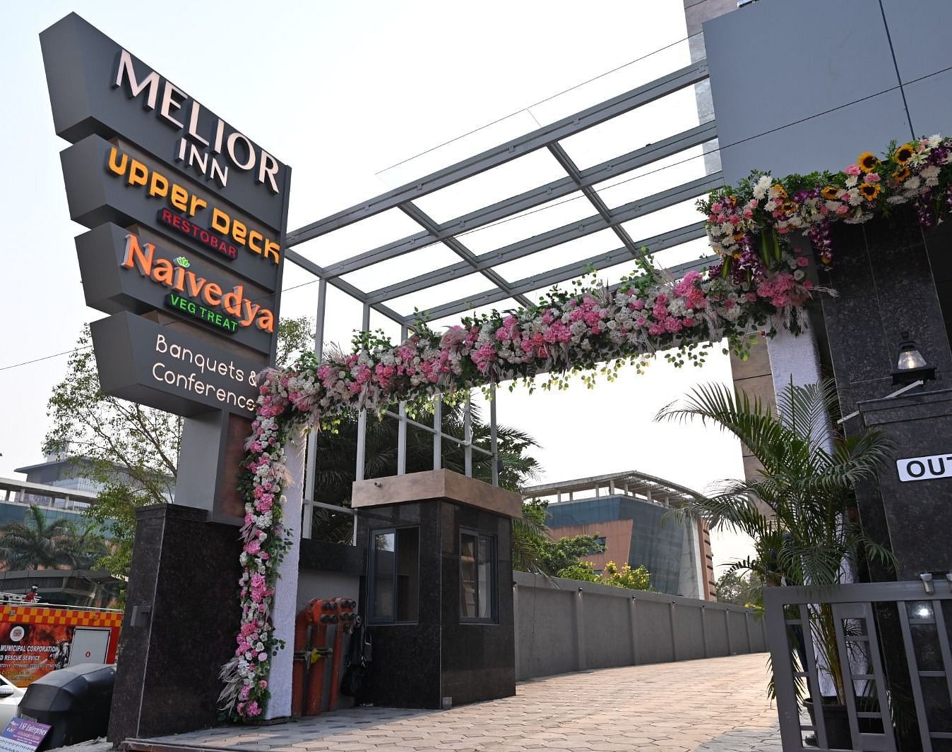 An exterior view of the entrance of Melior Inn with signage and some decoration.