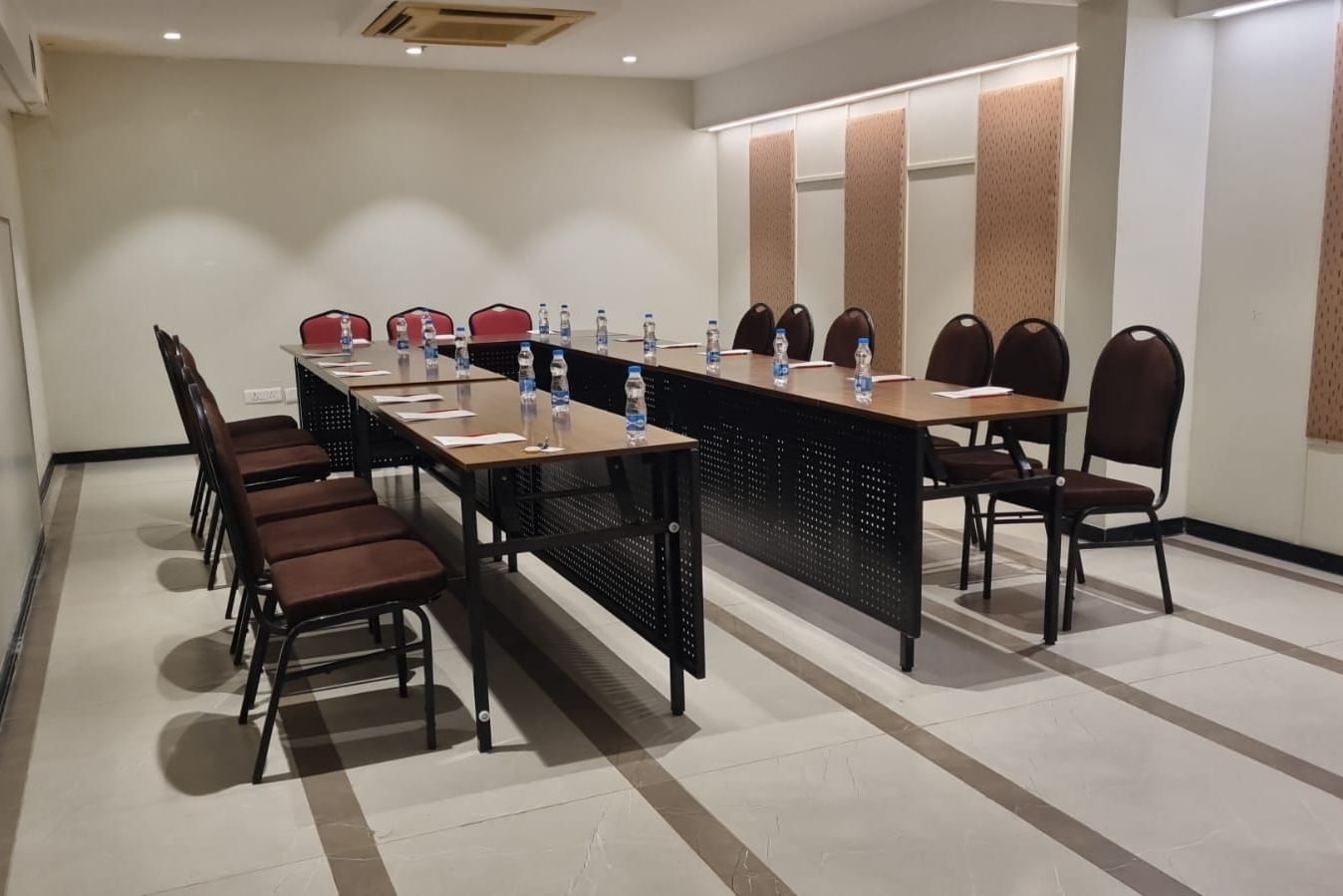 A conference room with a long table and chairs, set up for a formal meeting or presentation at Shilton Dee Cee.