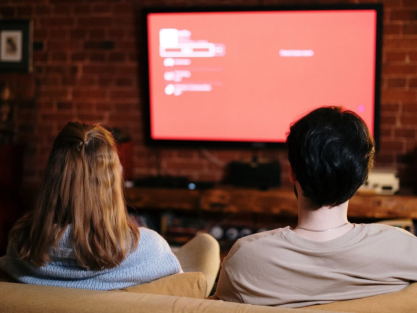 Two people watching television
