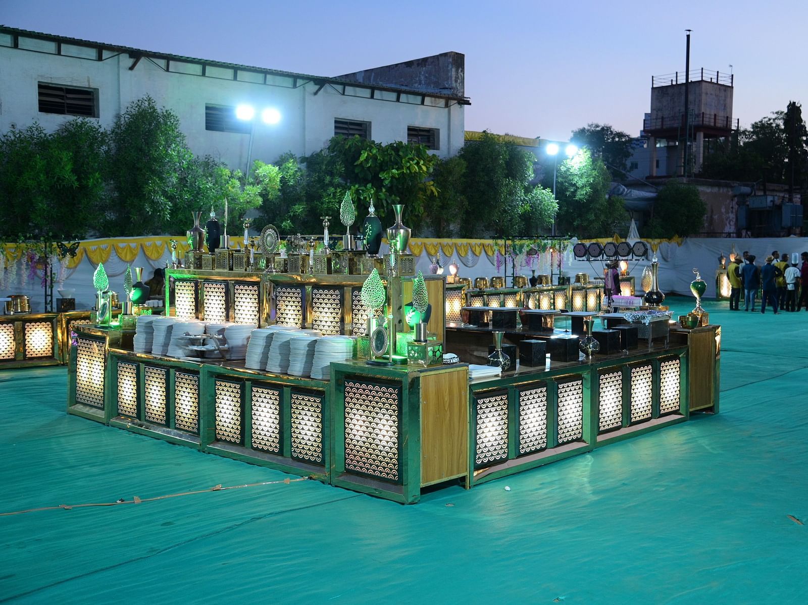 Outdoor event setup with food service stations and decorative lighting at Rang Lords Inn Bharuch