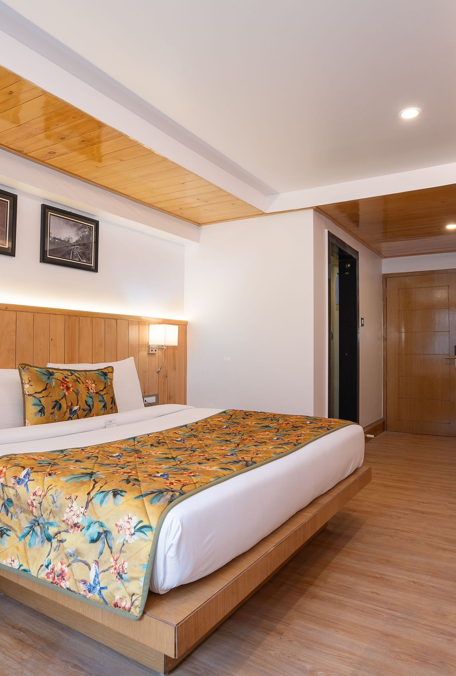 View of a king size bed and TV of Family View Room at Summit Grand Resort & Spa.