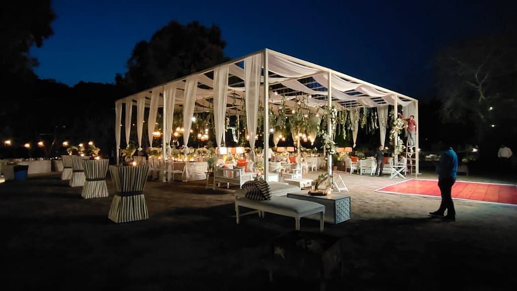 An image of a stage decorated with flowers and lights for the night