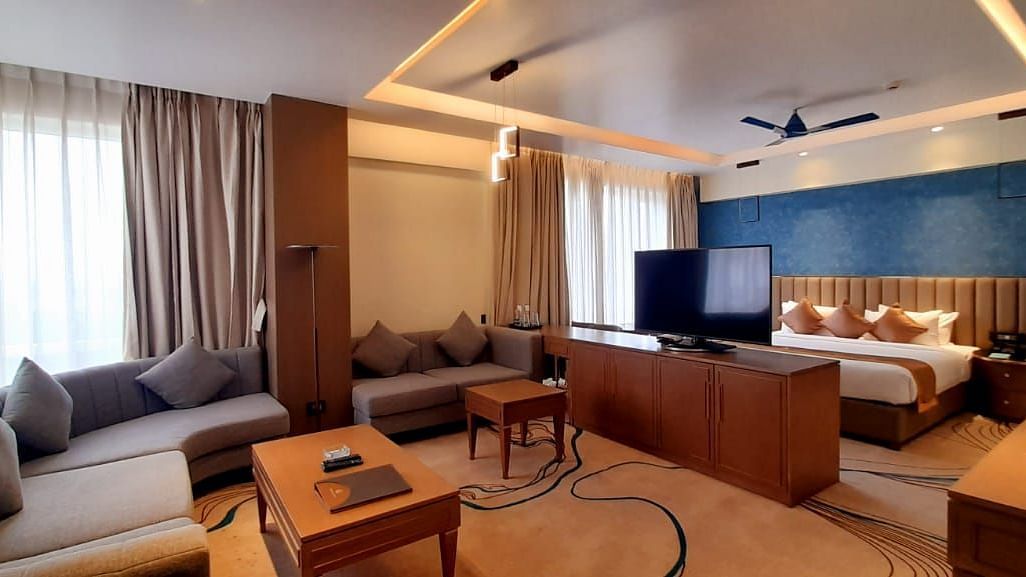 a view of the living room and the king size bed of M-Suite at Wonder country club resort
