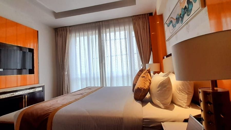 a view of a king bed and TV of C-Suite at Wonder country club resort