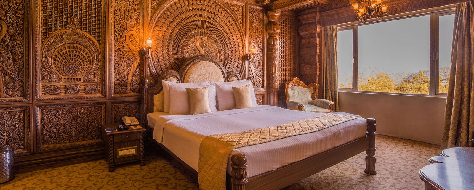 Room at Sitara Luxury Hotel in Hyderabad near Ramoji Film City with a double bed and side tables