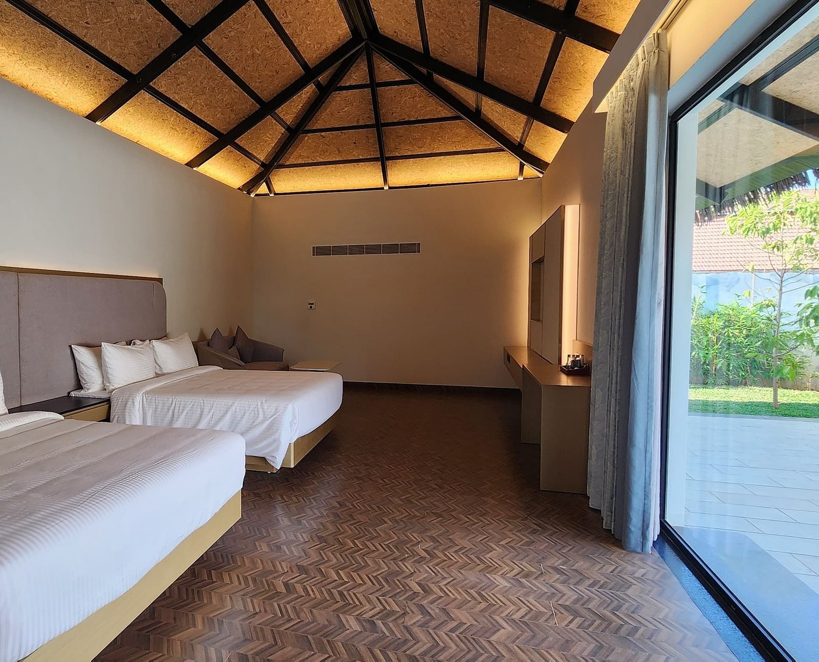 Corner view shot of the Exotic Pool Villa with the roof lined with yellow lighting at The Shore, Trishvam.