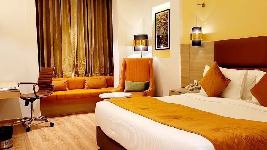 room with a king size bed and wooden flooring at best western vrindavan