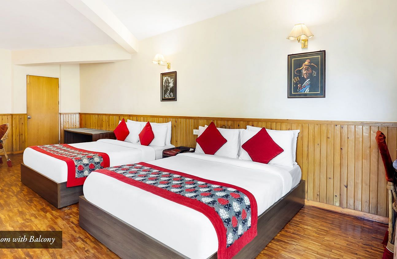 A side view of two beds in a room | Summit Newa Regency & Spa, Pelling