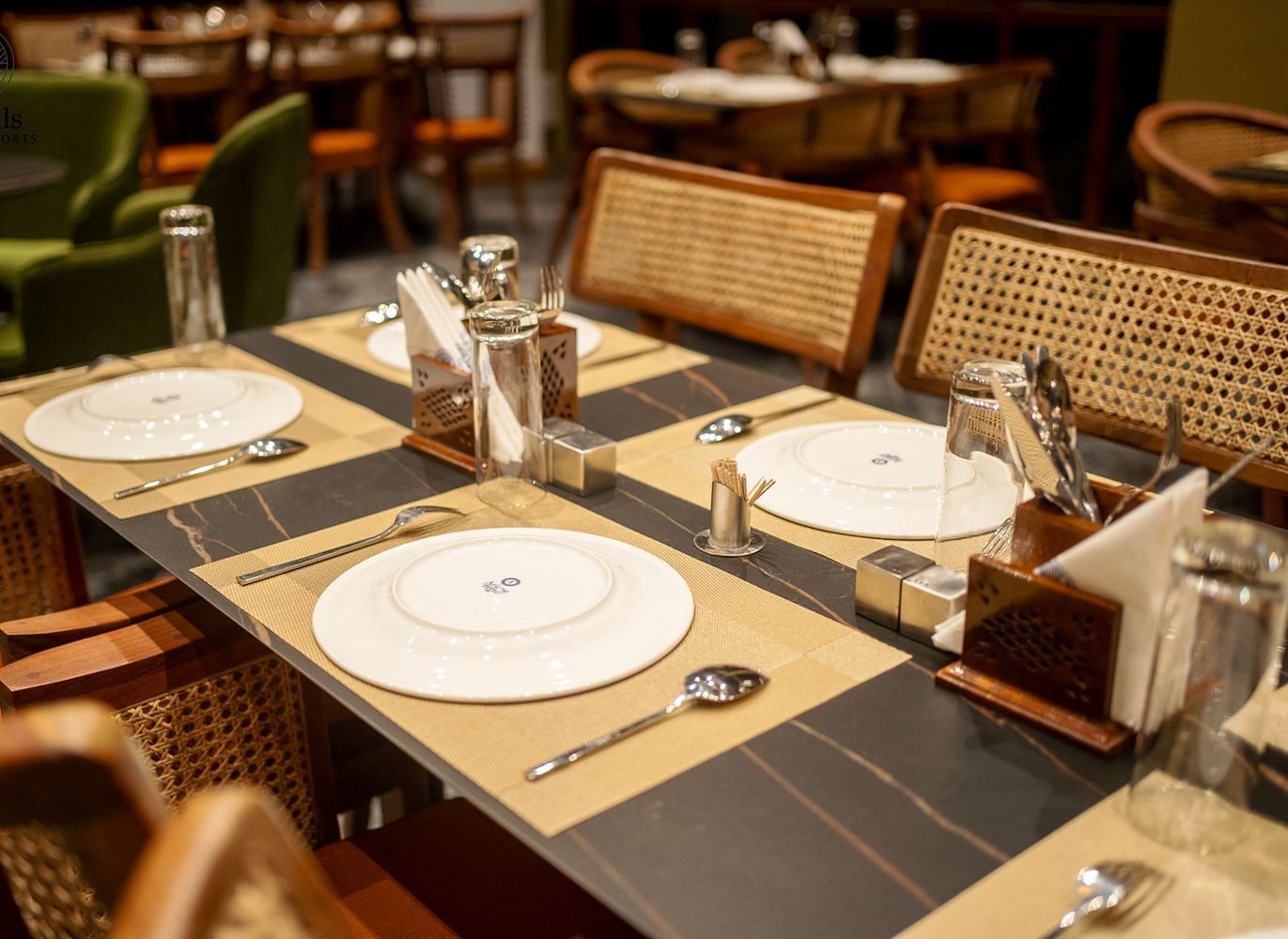 A well-appointed dining table with plates and glasses ready for a meal - Sea Hills Resort, Swaraj Dweep (Havelock)