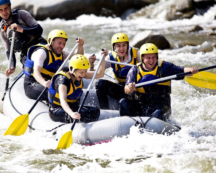 alt-text a group of people white water rafting