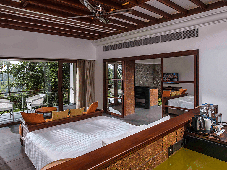 Spacious hotel room with wooden decor, large bed, and outdoor view.